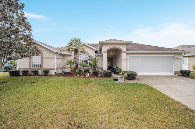 view of front of home with a front lawn and a garage