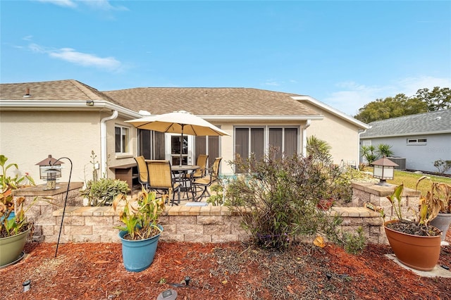 back of house with a patio