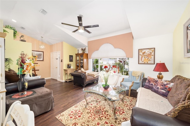 living room with ceiling fan with notable chandelier, dark hardwood / wood-style floors, and vaulted ceiling