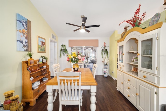 dining area featuring ceiling fan, dark wood-type flooring, and lofted ceiling