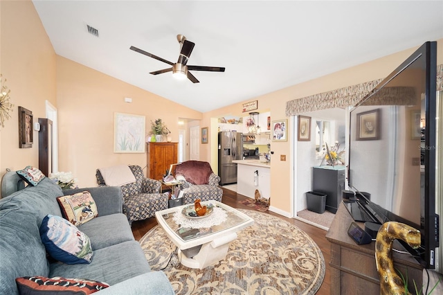 living room with ceiling fan, lofted ceiling, and dark hardwood / wood-style floors