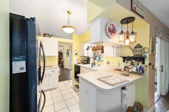 kitchen with kitchen peninsula, decorative light fixtures, black appliances, white cabinets, and sink