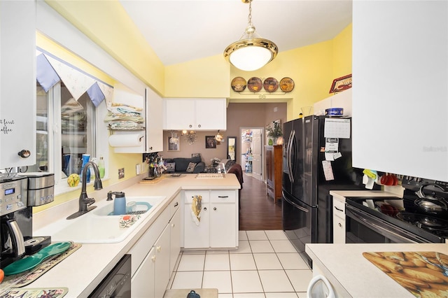 kitchen featuring black appliances, white cabinetry, sink, hanging light fixtures, and light tile patterned floors