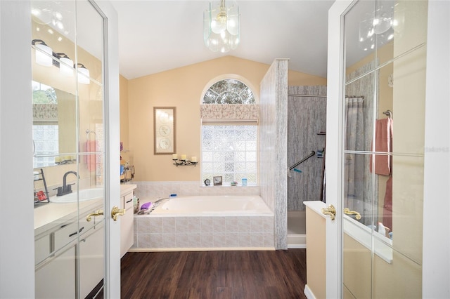 bathroom featuring hardwood / wood-style floors, vanity, lofted ceiling, and shower with separate bathtub