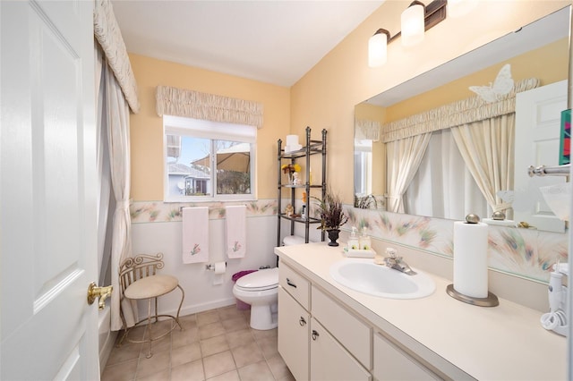 bathroom featuring toilet, vanity, and tile patterned flooring