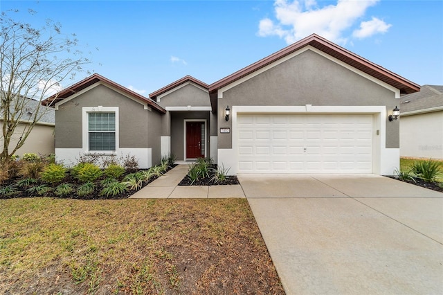 ranch-style home with a garage and a front lawn