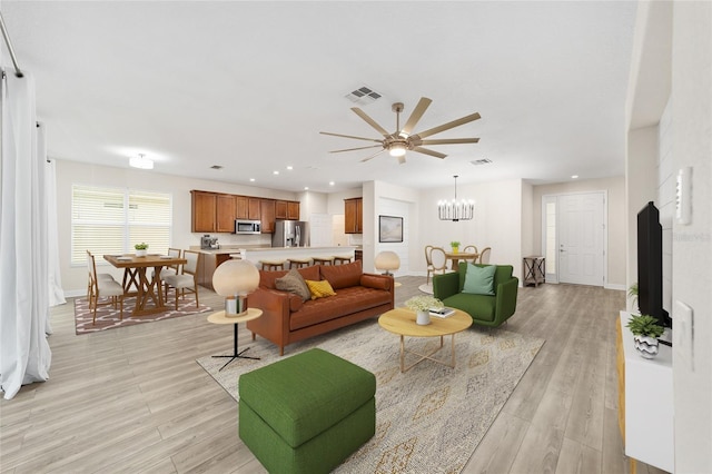 living room featuring a chandelier and light hardwood / wood-style flooring