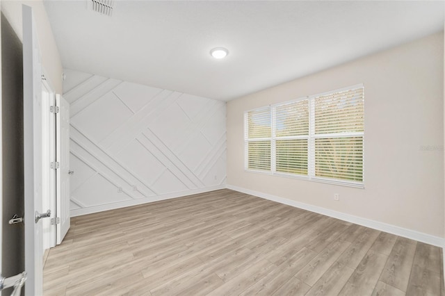 spare room with light hardwood / wood-style flooring