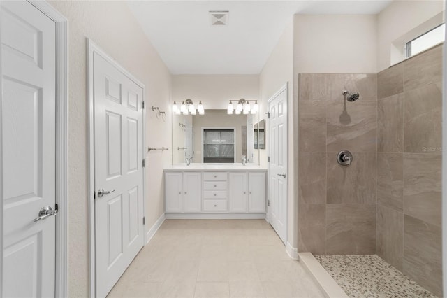 bathroom with vanity, tile patterned floors, and tiled shower