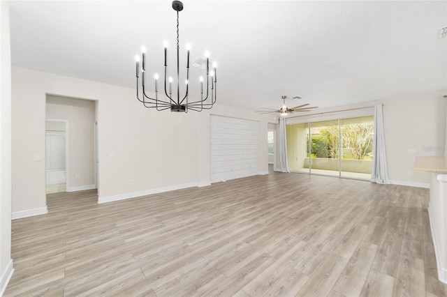 interior space with ceiling fan with notable chandelier and light hardwood / wood-style flooring