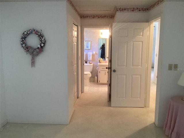 hallway featuring light colored carpet