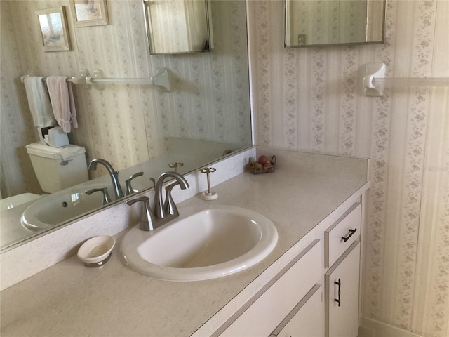 bathroom with toilet and vanity