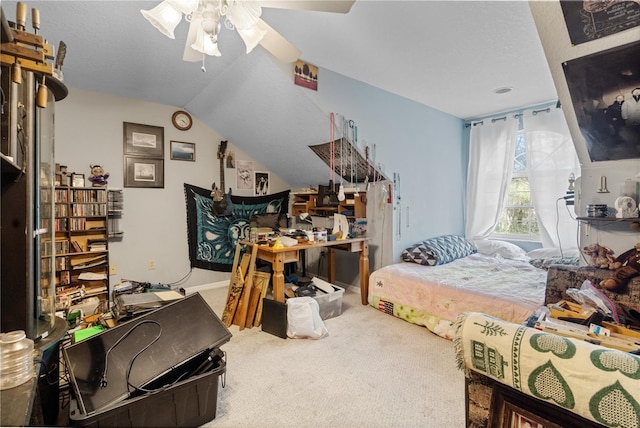 bedroom featuring lofted ceiling, carpet flooring, a textured ceiling, and ceiling fan