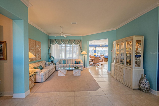 living room with ceiling fan, ornamental molding, and light tile patterned floors