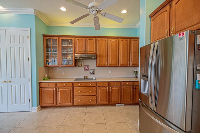 kitchen with light tile patterned flooring, ceiling fan, stainless steel fridge with ice dispenser, crown molding, and black electric cooktop