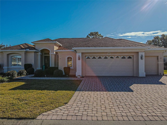 view of front facade with a garage and a front lawn