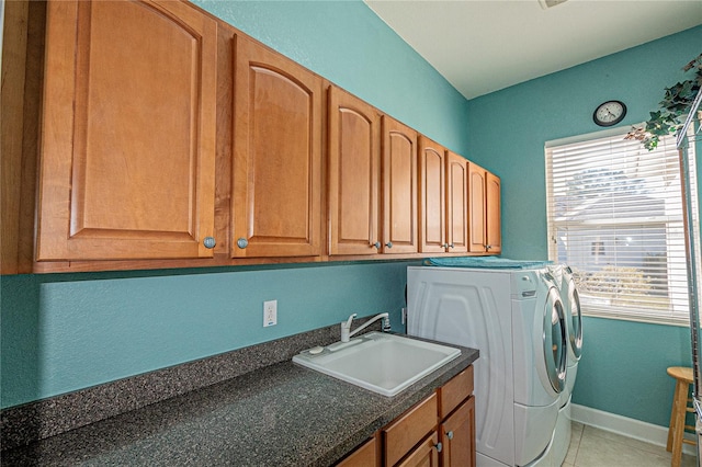 laundry room featuring cabinets, separate washer and dryer, sink, and light tile patterned floors