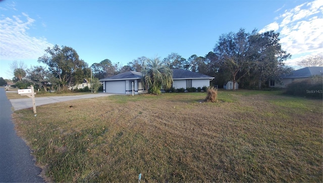 ranch-style home with a front lawn and a garage