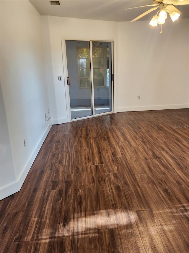 spare room featuring ceiling fan and dark hardwood / wood-style flooring