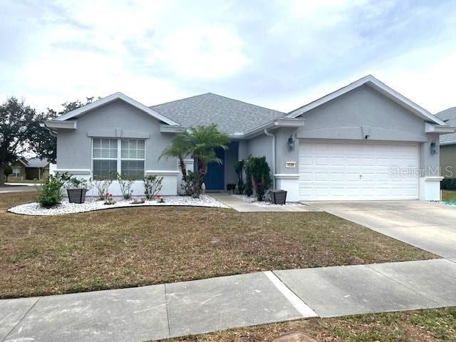 single story home with a front lawn and a garage