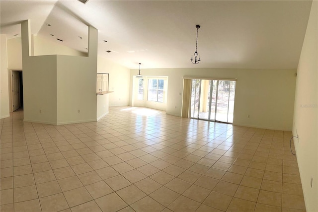 spare room featuring light tile patterned floors and high vaulted ceiling