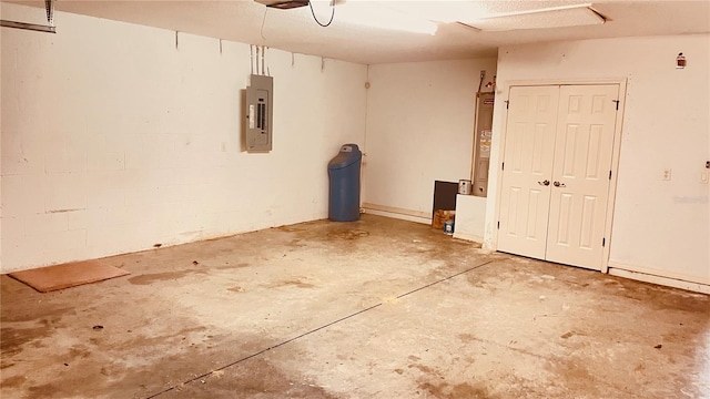 garage featuring electric panel and electric water heater