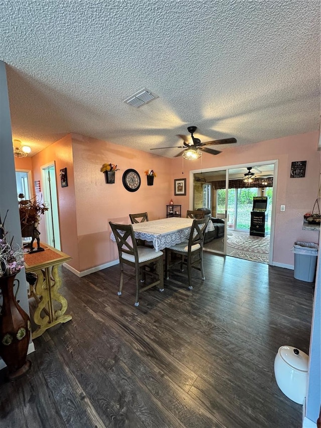 dining space with ceiling fan and dark hardwood / wood-style floors