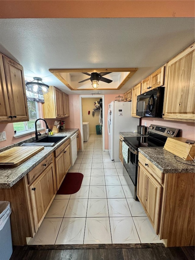 kitchen featuring white appliances, a textured ceiling, sink, a raised ceiling, and ceiling fan