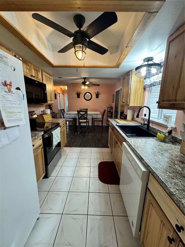 kitchen with ceiling fan, white appliances, sink, and a tray ceiling