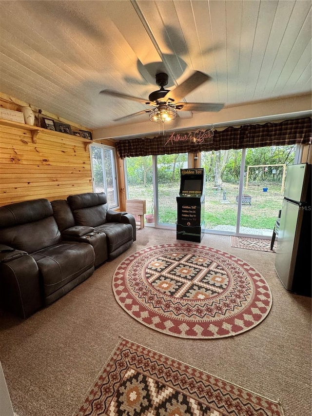 living room with ceiling fan, wooden ceiling, carpet floors, and vaulted ceiling