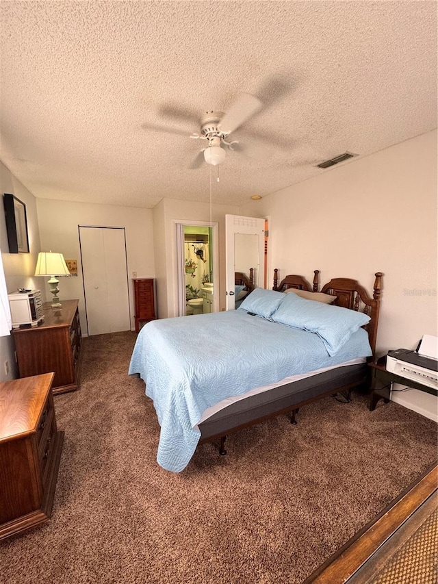 carpeted bedroom with ceiling fan and a textured ceiling