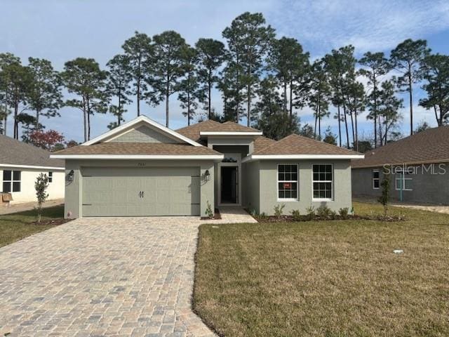 view of front of house featuring a front yard and a garage