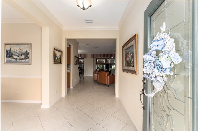 hall with light tile patterned flooring and ornamental molding