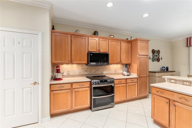 kitchen with light tile patterned floors, crown molding, appliances with stainless steel finishes, and decorative backsplash