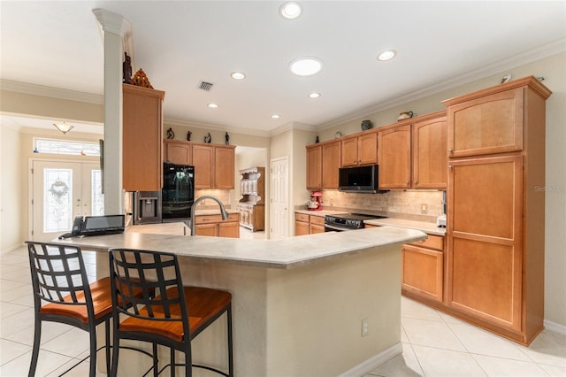 kitchen with tasteful backsplash, stainless steel electric range, a kitchen bar, ornamental molding, and light tile patterned floors