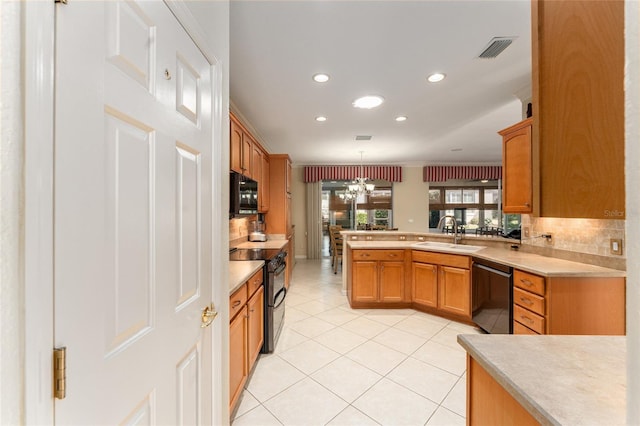 kitchen with kitchen peninsula, light tile patterned flooring, hanging light fixtures, black appliances, and sink