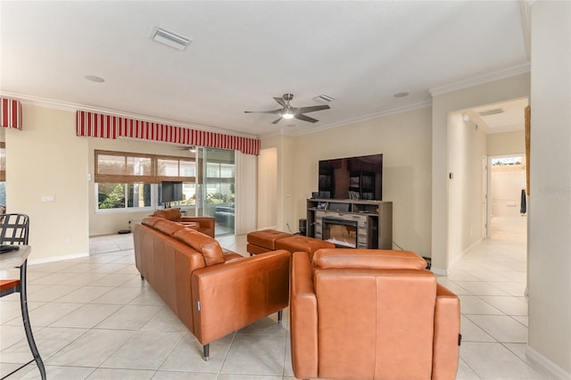 tiled living room featuring ceiling fan, ornamental molding, and a fireplace