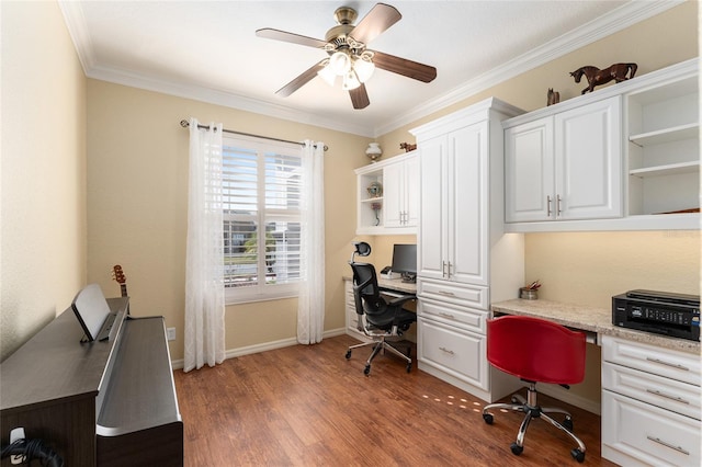 office featuring ceiling fan, dark hardwood / wood-style floors, crown molding, and built in desk