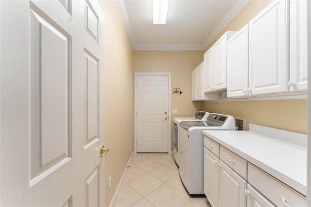 clothes washing area featuring cabinets, light tile patterned floors, crown molding, and separate washer and dryer