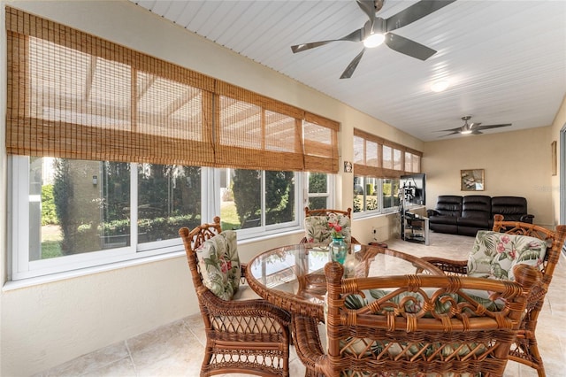 sunroom / solarium featuring ceiling fan and a healthy amount of sunlight