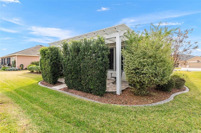 view of side of property featuring a pergola and a yard