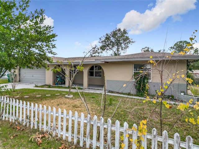 single story home with a front lawn and a garage