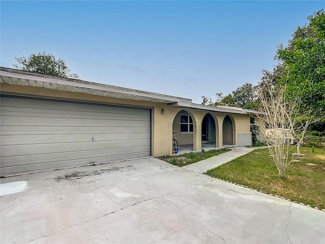 ranch-style home featuring a front yard and a garage