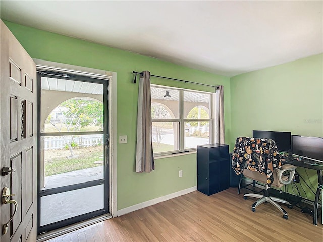 home office with light hardwood / wood-style floors