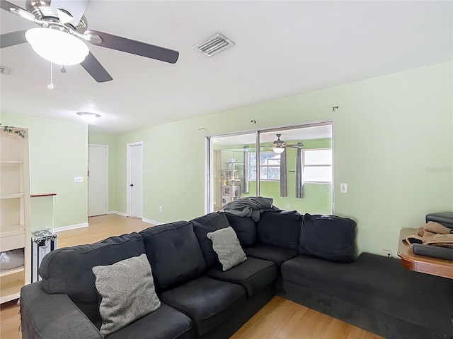 living room featuring ceiling fan and light hardwood / wood-style flooring