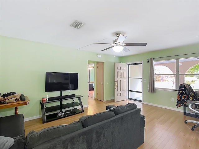 living room featuring ceiling fan and light wood-type flooring