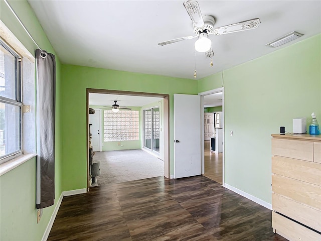 interior space with ceiling fan and dark hardwood / wood-style flooring