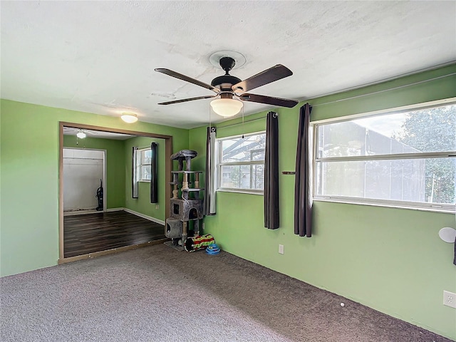 carpeted empty room with a textured ceiling