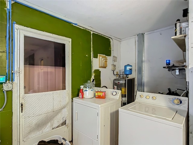 laundry room with washing machine and dryer and water heater