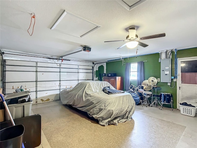 garage with ceiling fan, a garage door opener, and electric panel